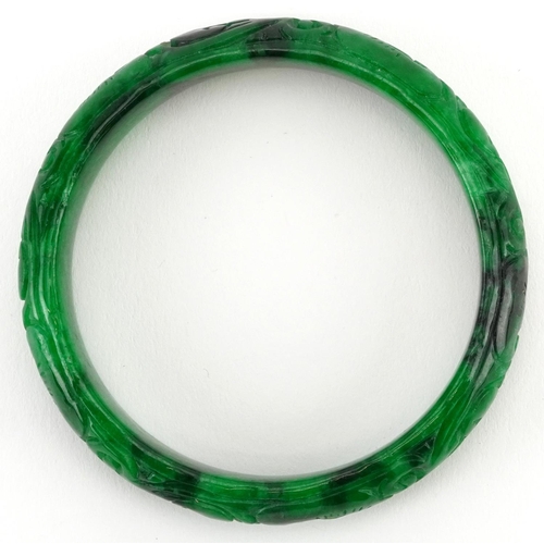 2220 - Chinese green jade bangle carved with foliage, 7cm in diameter, 47.0g