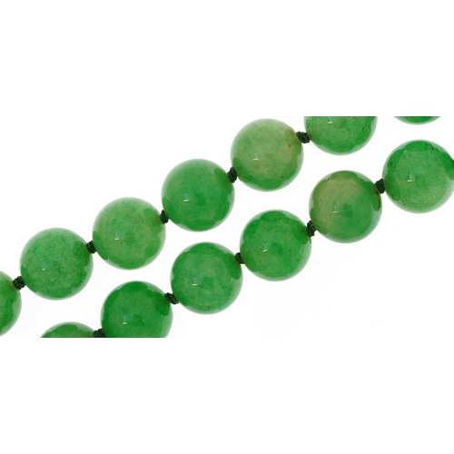 2053 - Chinese green jade bead necklace, each bead 12mm in diameter, overall 90cm in length, 159.2g