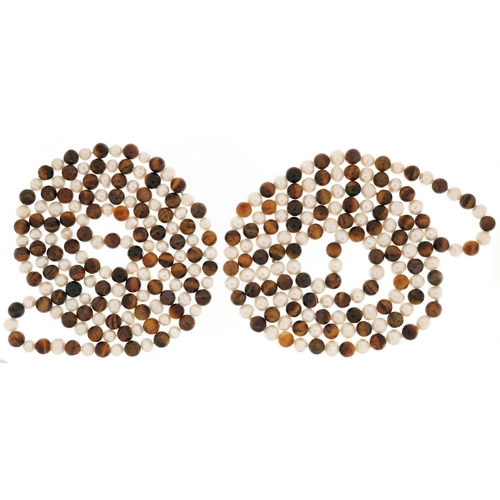 2601 - Two freshwater pearl and tiger's eye bead necklaces, each 120cm in length, total 214.3g