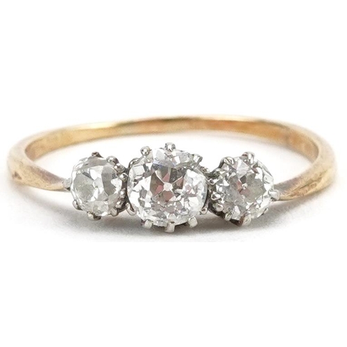 2035 - Unmarked gold diamond three stone ring, tests as 18ct gold, total diamond weight approximately 0.60 ... 