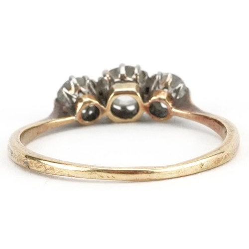 2035 - Unmarked gold diamond three stone ring, tests as 18ct gold, total diamond weight approximately 0.60 ... 