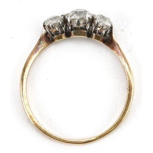 2035 - Unmarked gold diamond three stone ring, tests as 18ct gold, total diamond weight approximately 0.60 ... 