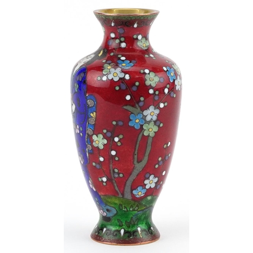 84 - Japanese cloisonne vase enamelled with a Geisha in a landscape with flowers, 13.5cm high