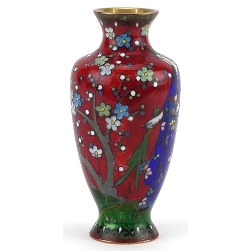 84 - Japanese cloisonne vase enamelled with a Geisha in a landscape with flowers, 13.5cm high