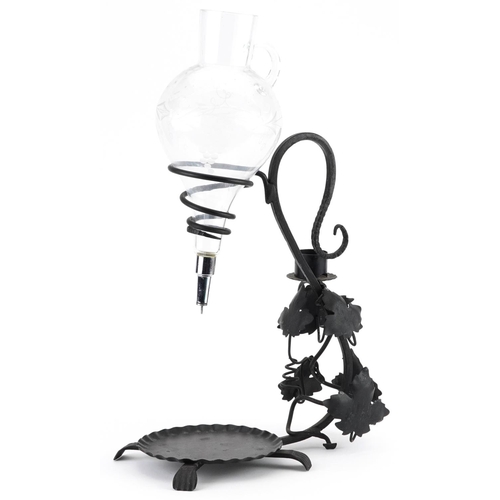 1305 - 19th century style iron and glass wine decanter, 47.5cm high