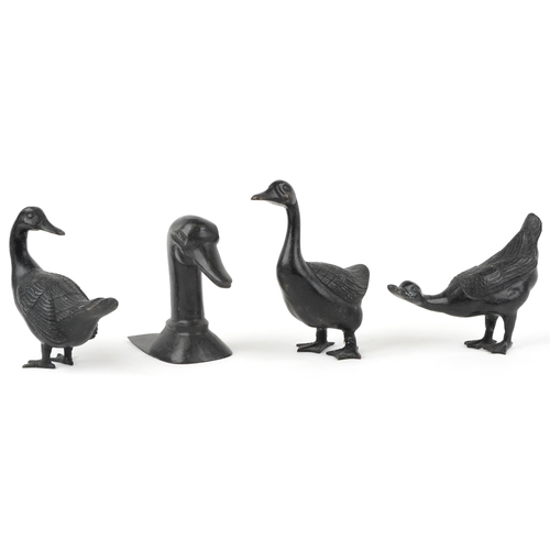 423 - Three patinated bronze ducks and a patinated bronze book end in the form of a duck's head, the large... 