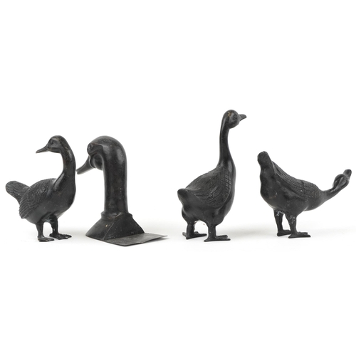 423 - Three patinated bronze ducks and a patinated bronze book end in the form of a duck's head, the large... 