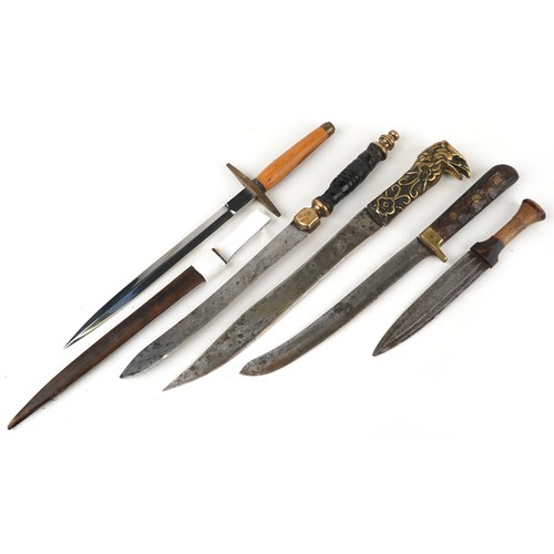 673 - Five edged weapons including example with brass eagle design handle, the largest 46cm in length