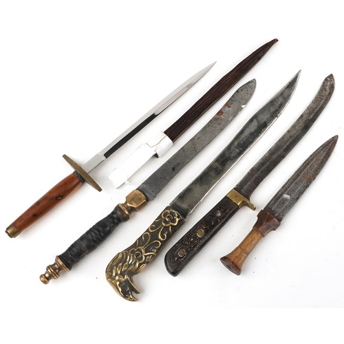 673 - Five edged weapons including example with brass eagle design handle, the largest 46cm in length