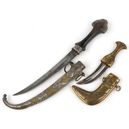 674 - Two Islamic knives including one with silver overlaid brass sheath, 40.5cm in length