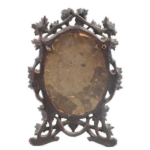 92 - 19th century German Black Forest photo frame carved with foliage housing a hand coloured engraving o... 