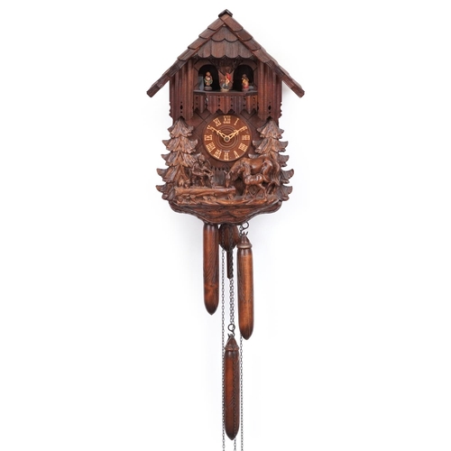 442 - German Black Forest wall clock carved with a farrier beside horse and foal, 36cm high