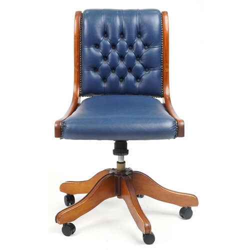 1038 - Mahogany and blue leather button back upholstered adjustable desk chair, 89cm high