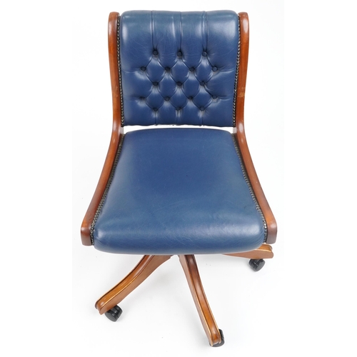 1038 - Mahogany and blue leather button back upholstered adjustable desk chair, 89cm high