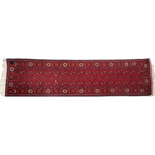 1109 - Rectangular Bokhara red ground carpet runner, 300cm x 82cm