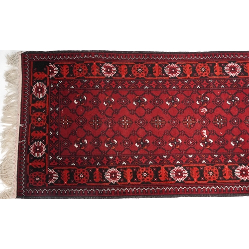 1109 - Rectangular Bokhara red ground carpet runner, 300cm x 82cm