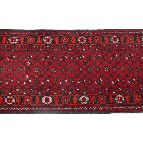 1109 - Rectangular Bokhara red ground carpet runner, 300cm x 82cm