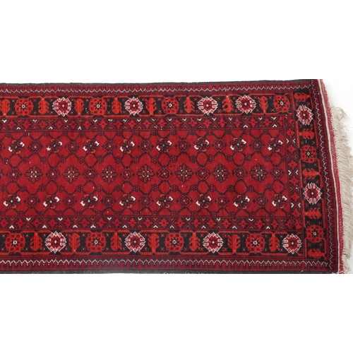 1109 - Rectangular Bokhara red ground carpet runner, 300cm x 82cm