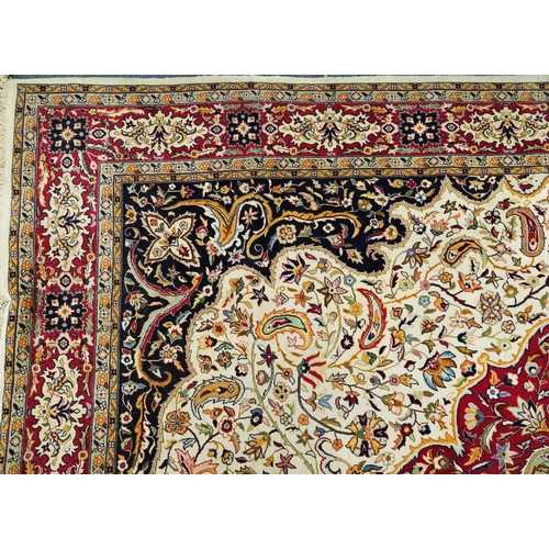 1106 - Rectangular Persian cream and red ground rug having an all over repeat floral design, 370cm x 270cm