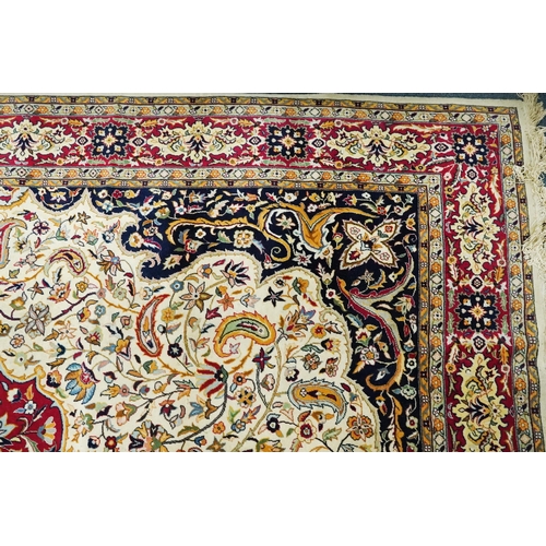 1106 - Rectangular Persian cream and red ground rug having an all over repeat floral design, 370cm x 270cm