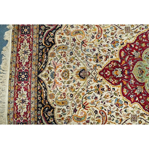 1106 - Rectangular Persian cream and red ground rug having an all over repeat floral design, 370cm x 270cm