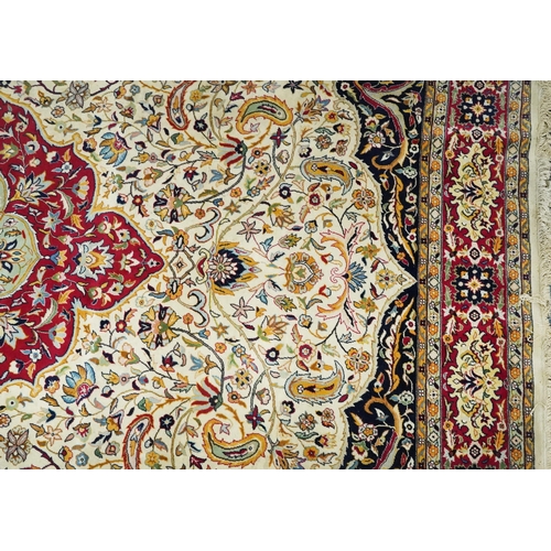 1106 - Rectangular Persian cream and red ground rug having an all over repeat floral design, 370cm x 270cm