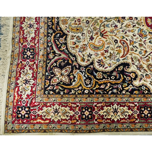 1106 - Rectangular Persian cream and red ground rug having an all over repeat floral design, 370cm x 270cm