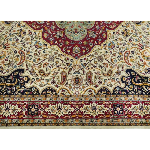 1106 - Rectangular Persian cream and red ground rug having an all over repeat floral design, 370cm x 270cm