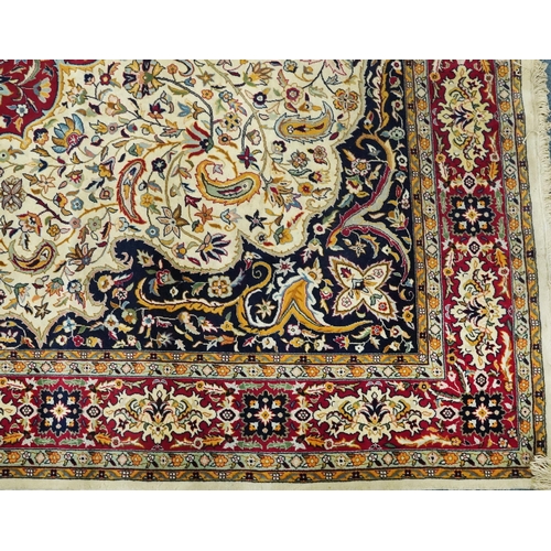 1106 - Rectangular Persian cream and red ground rug having an all over repeat floral design, 370cm x 270cm