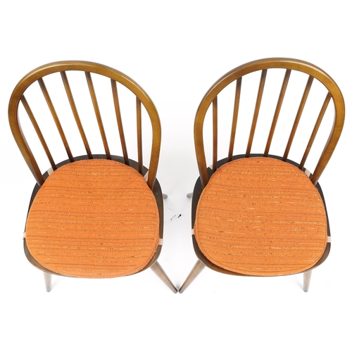 1035 - Two Ercol stick back dining chairs with cushioned seats, each 83cm high