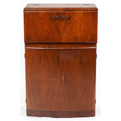 1069 - Art Deco walnut cocktail cabinet fitted with a fall enclosing a mirrored interior above a cupboard b... 