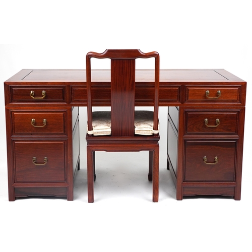 1005 - Chinese rosewood twin pedestal desk fitted with an arrangement of seven drawers, with matching chair... 