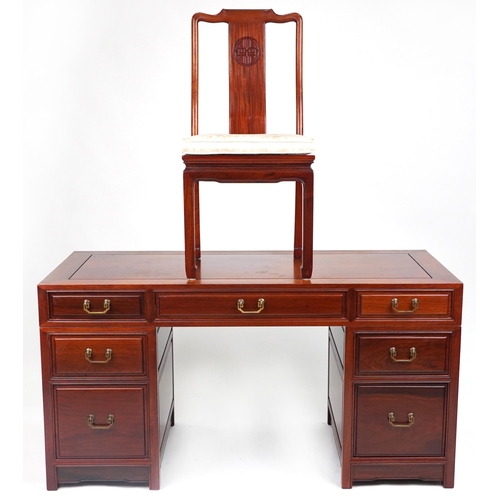 1005 - Chinese rosewood twin pedestal desk fitted with an arrangement of seven drawers, with matching chair... 