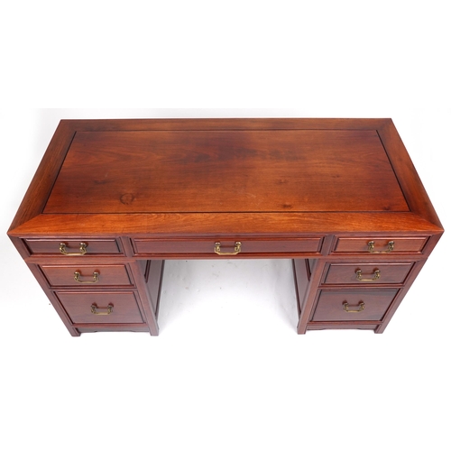 1005 - Chinese rosewood twin pedestal desk fitted with an arrangement of seven drawers, with matching chair... 