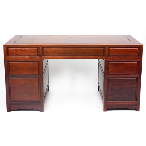 1005 - Chinese rosewood twin pedestal desk fitted with an arrangement of seven drawers, with matching chair... 