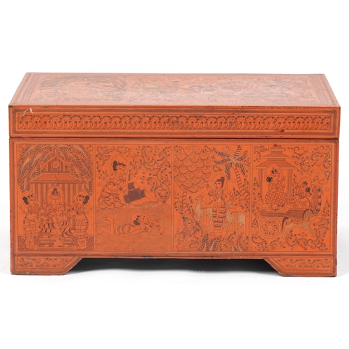 1065 - Burmese red lacquered trunk with hinged lid profusely hand painted with panels of deities in landsca... 