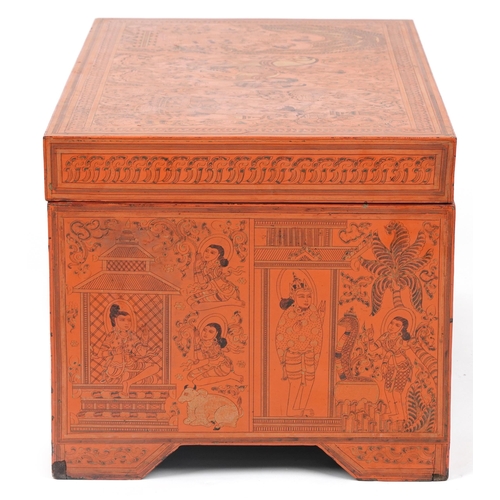 1065 - Burmese red lacquered trunk with hinged lid profusely hand painted with panels of deities in landsca... 