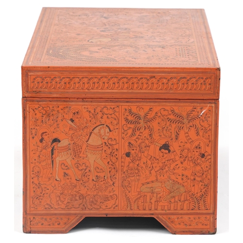 1065 - Burmese red lacquered trunk with hinged lid profusely hand painted with panels of deities in landsca... 