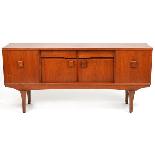 1050 - Mid century teak sideboard fitted with an arrangement of two drawers and four cupboard doors, 76cm H... 