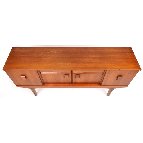 1050 - Mid century teak sideboard fitted with an arrangement of two drawers and four cupboard doors, 76cm H... 