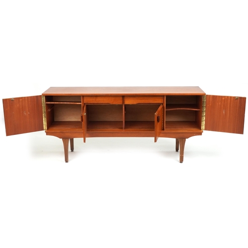 1050 - Mid century teak sideboard fitted with an arrangement of two drawers and four cupboard doors, 76cm H... 