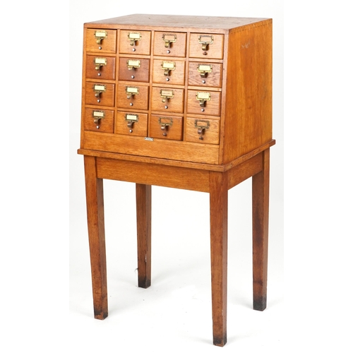 Libraco, oak sixteen drawer haberdashery chest on stand, 128.5cm H x 66cm W x 50cm D