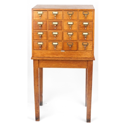 1060 - Libraco, oak sixteen drawer haberdashery chest on stand, 128.5cm H x 66cm W x 50cm D