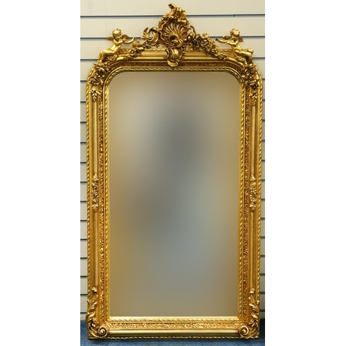 1116 - Large ornate gilt framed mirror having bevelled glass mounted with Putti and swags, 62cm x 84cm