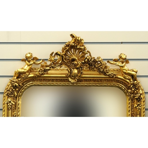 1116 - Large ornate gilt framed mirror having bevelled glass mounted with Putti and swags, 62cm x 84cm