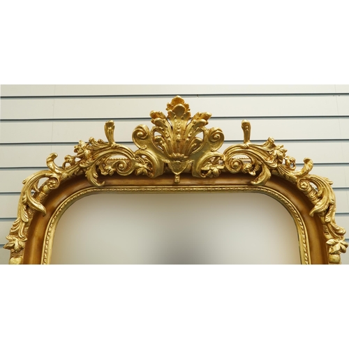 1110 - Large ornate gilt framed wall mirror having bevelled glass mounted with flowers and foliage, 220cm x... 