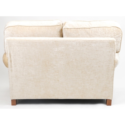 1034 - Contemporary beige upholstered two seater settee, 100cm H x 145cm W x 100cm D