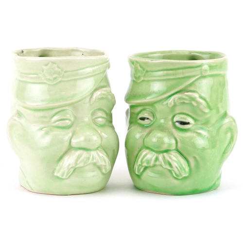 650 - Pair of military interest green glazed mugs in the form of Bruce Bairnsfather's Old Bill, each 11.5c... 