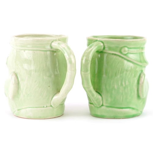 650 - Pair of military interest green glazed mugs in the form of Bruce Bairnsfather's Old Bill, each 11.5c... 