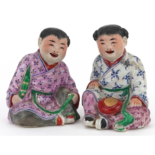 1325 - Pair of Chinese porcelain figures of children wearing robes, the largest 9.5cm high